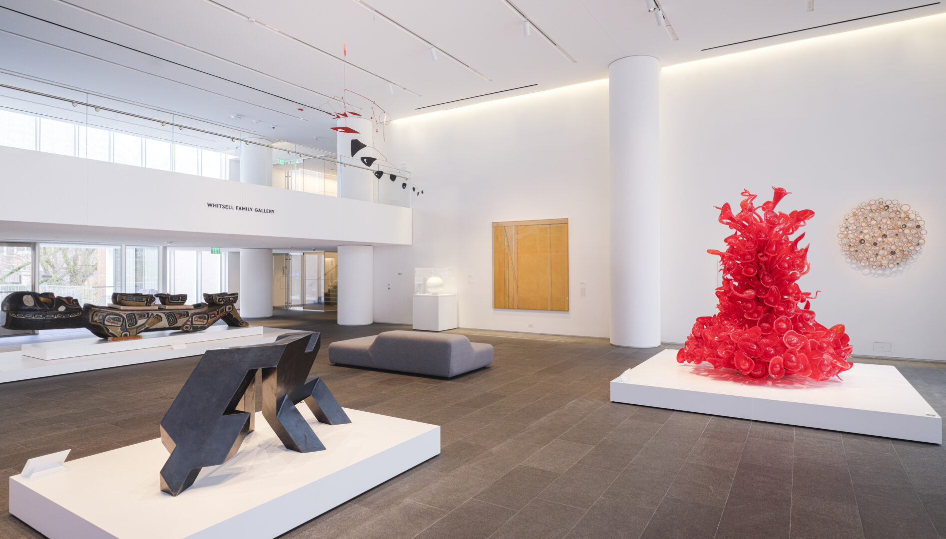Gallery installation photo with various artworks in view.