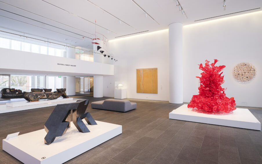 Gallery installation photo with various artworks in view.