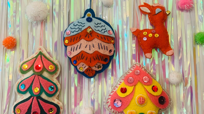 Photo of handmade ornaments against a sparkly tinsel wall