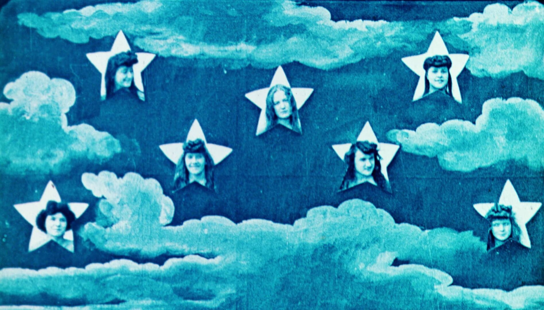 Seven human heads superimposed over stars floating in clouds.