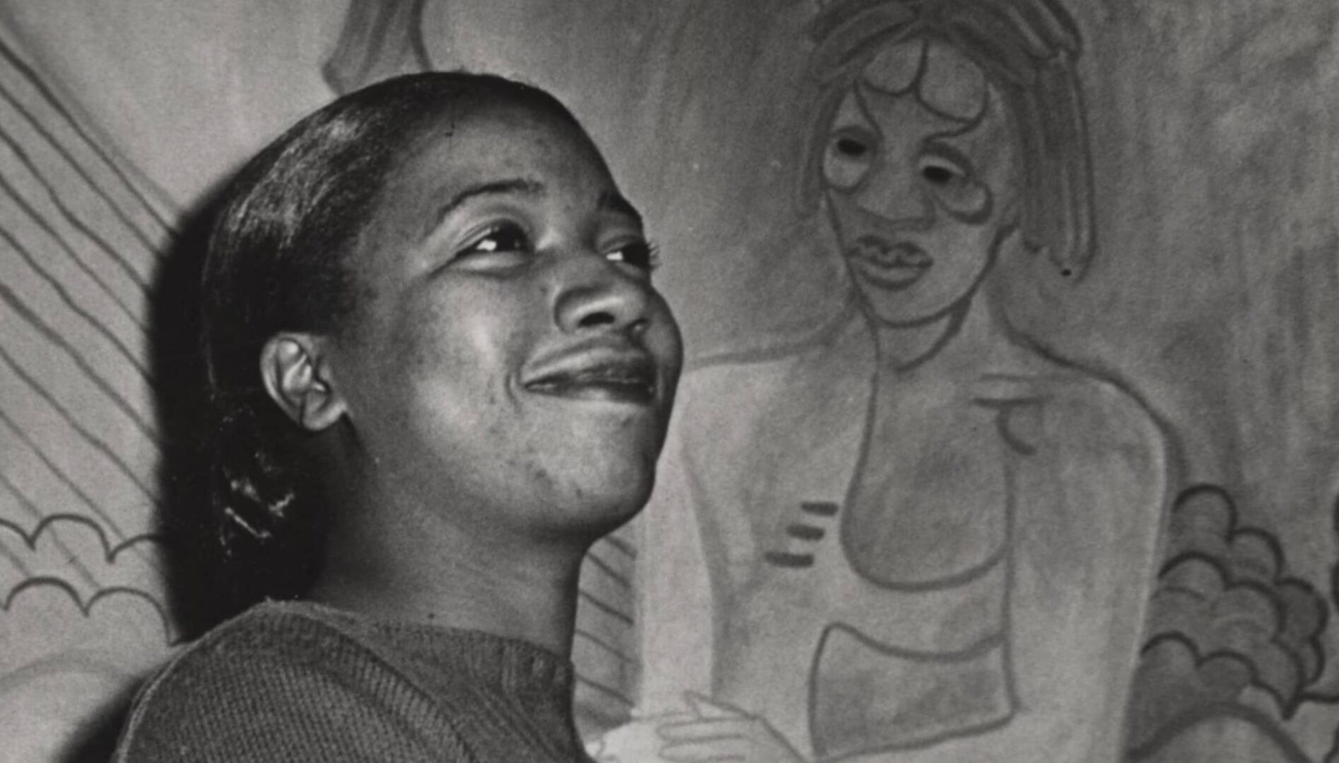 A person standing in front of a painting.