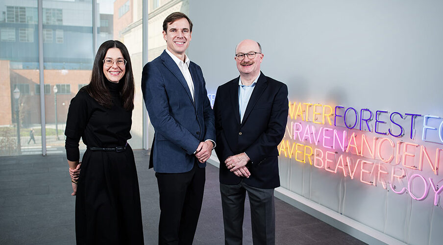3 people standing in an art gallery