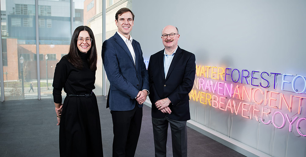 3 people standing in an art gallery