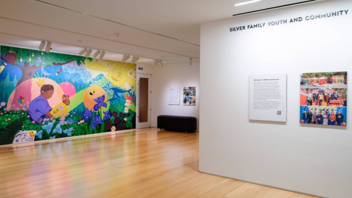 Interior gallery space with a colorful wall mural.
