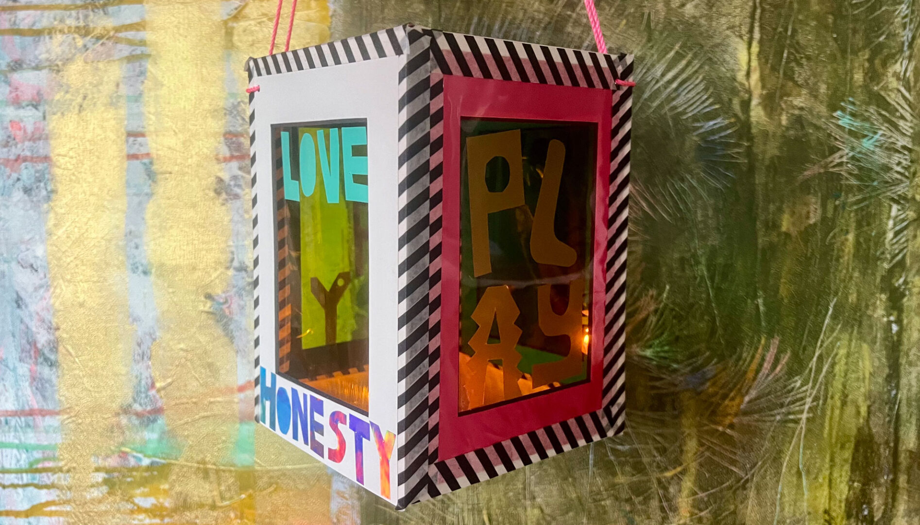 Handmade lantern with the words Love, Honesty, and Play on it