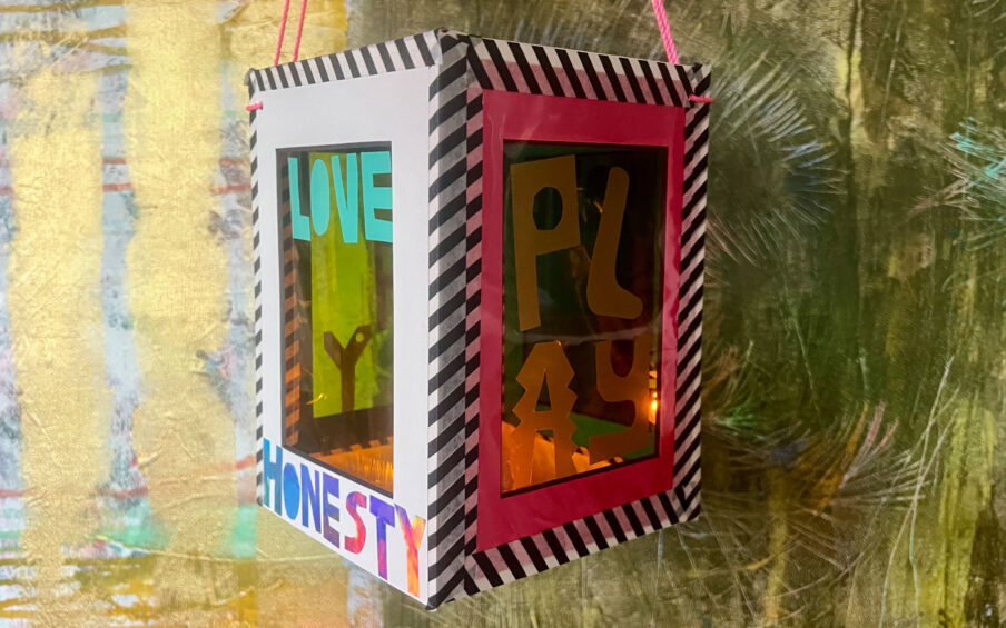 Handmade lantern with the words Love, Honesty, and Play on it