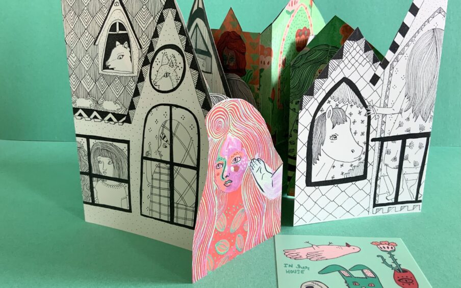 Photo of an illustrated house built of paper.