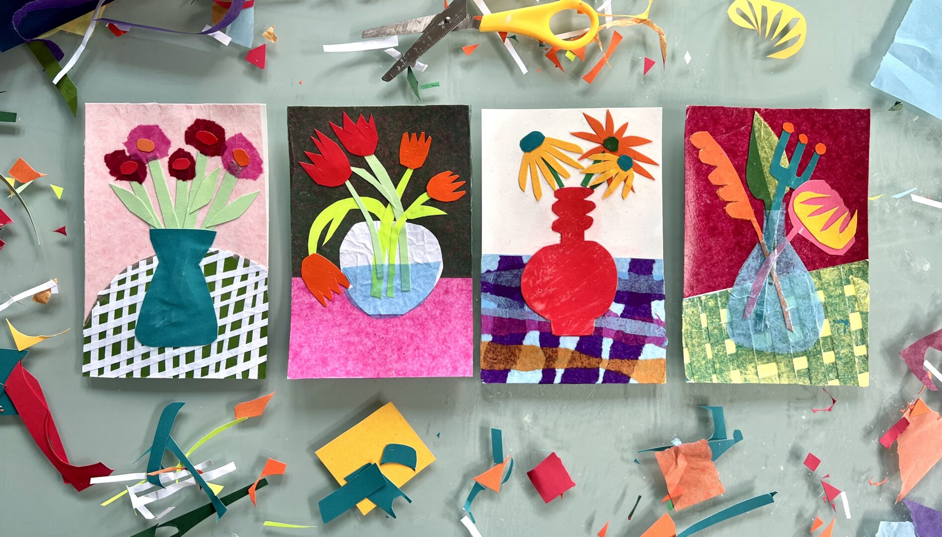 Photo of flower collages with the art tools and paper scraps surrounding them.