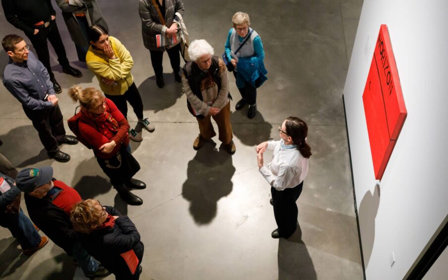 A small group of people in a gallery space.