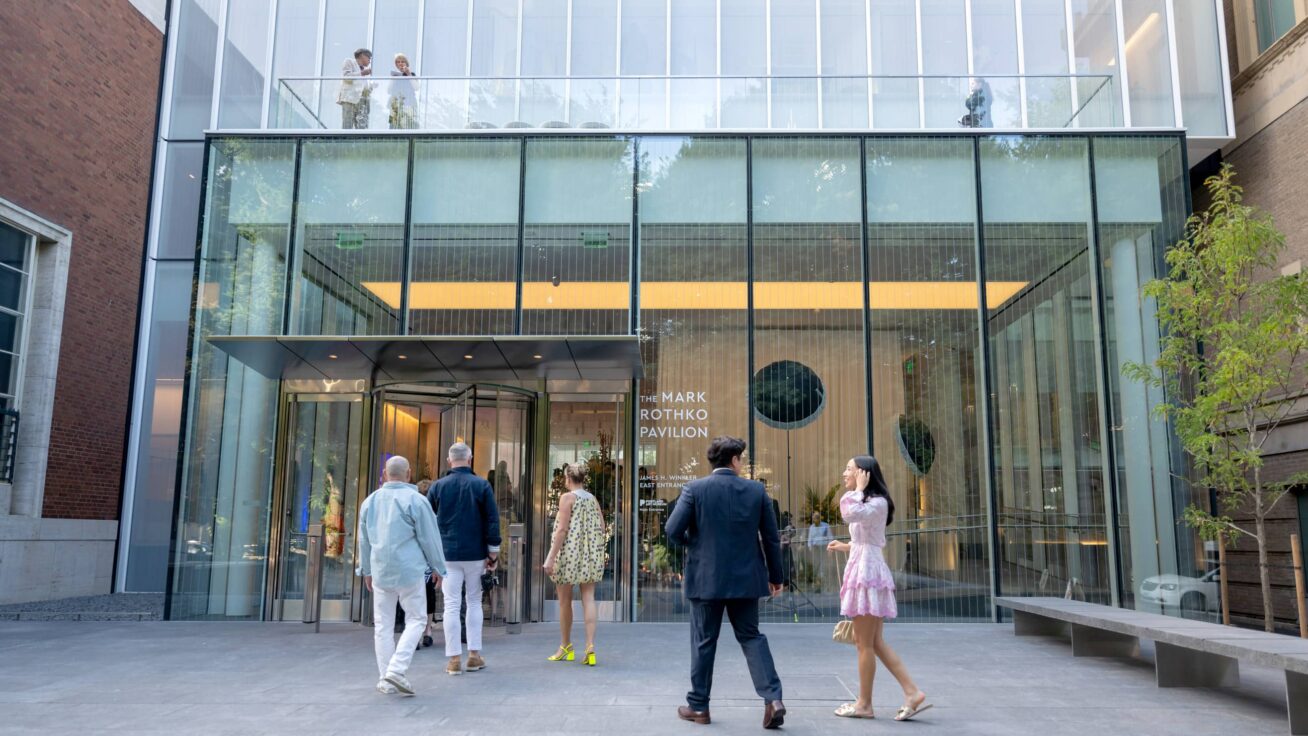 Exterior of the Museum entrance with people entering the building.
