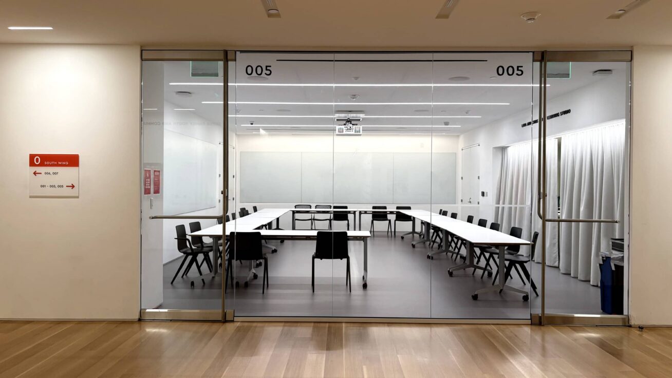 Interior room behind a wall of windows.