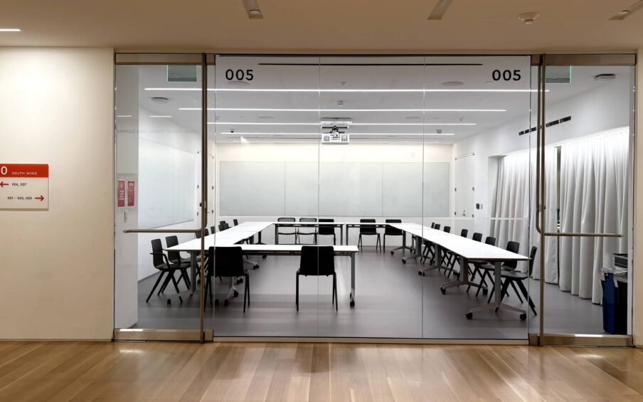 Interior room behind a wall of windows.