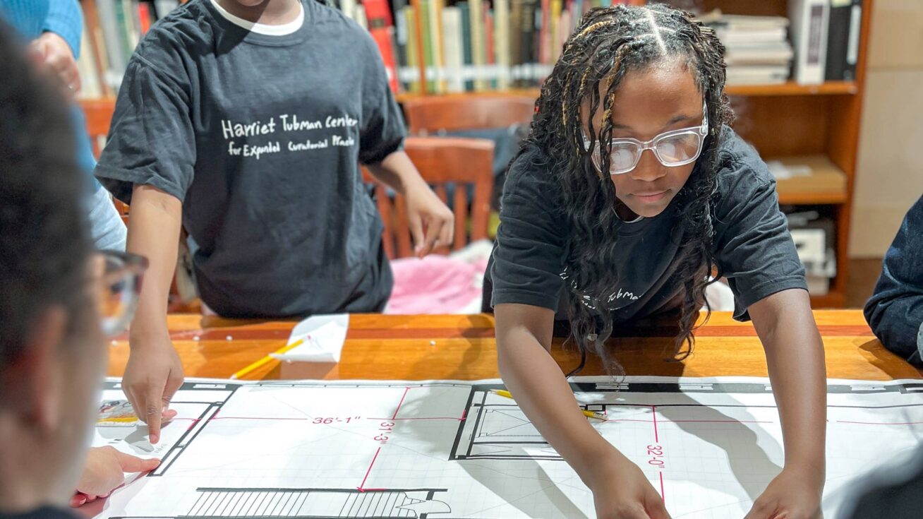 A young person working at a table.