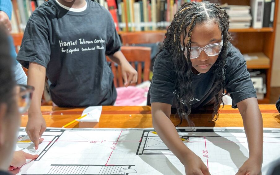 A young person working at a table.