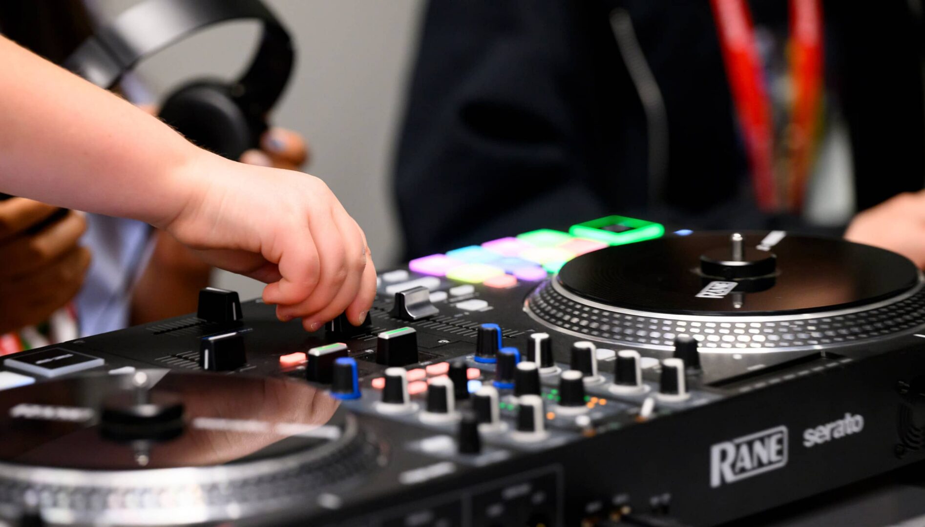 Hands manipulating DJ equipment.