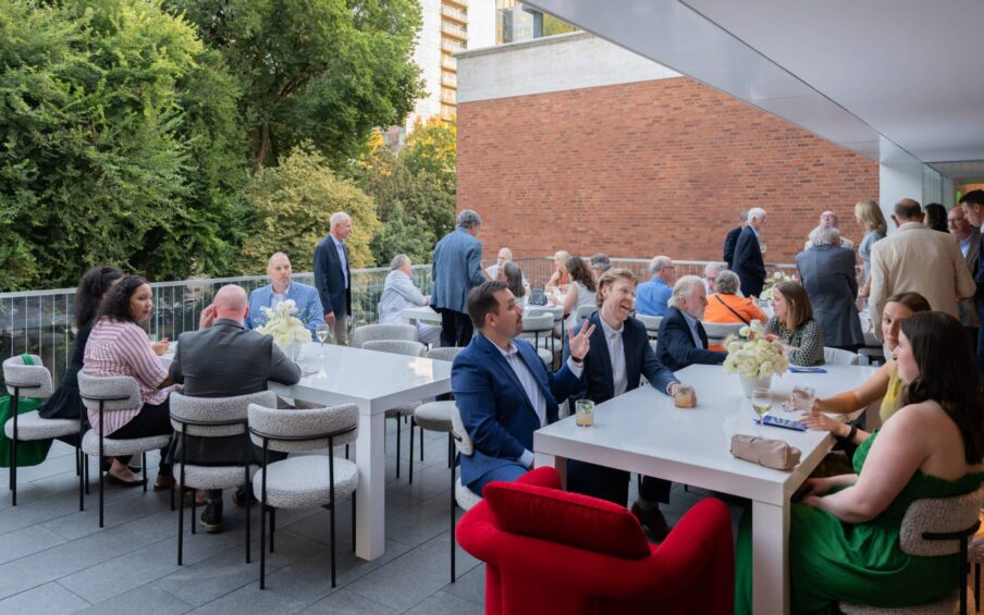 An outdoor terrace with people seated at tables.