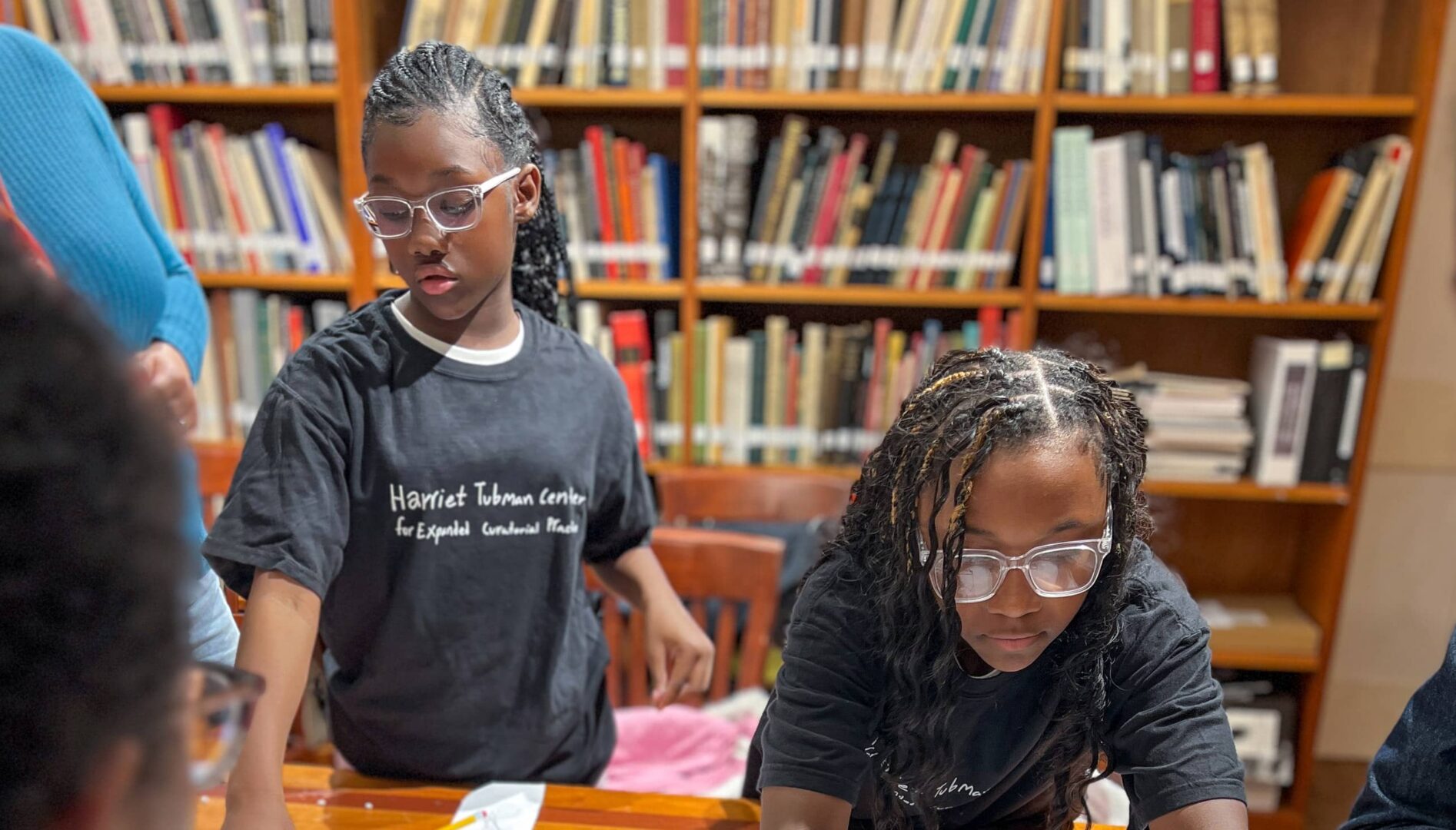 Two young people working on an exhibit layout.