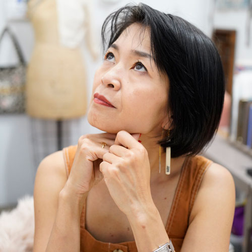 Portrait of a woman looking up to the righthand side of the frame.