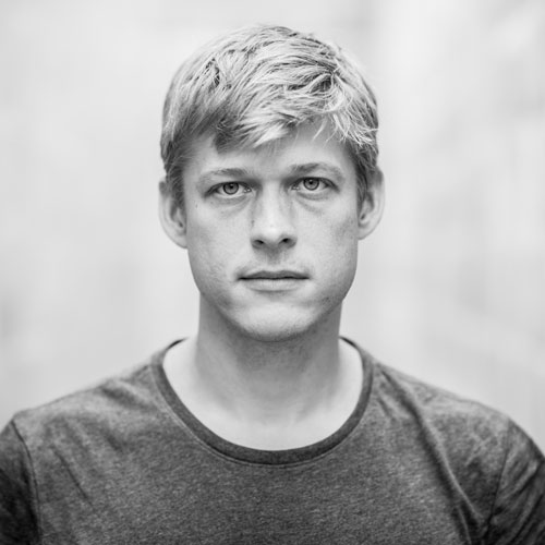 Black and white photo of a man with light-colored, short hair