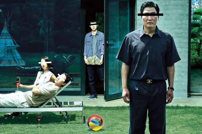 Four people standing outside a house. Blocks of color cover their eyes.
