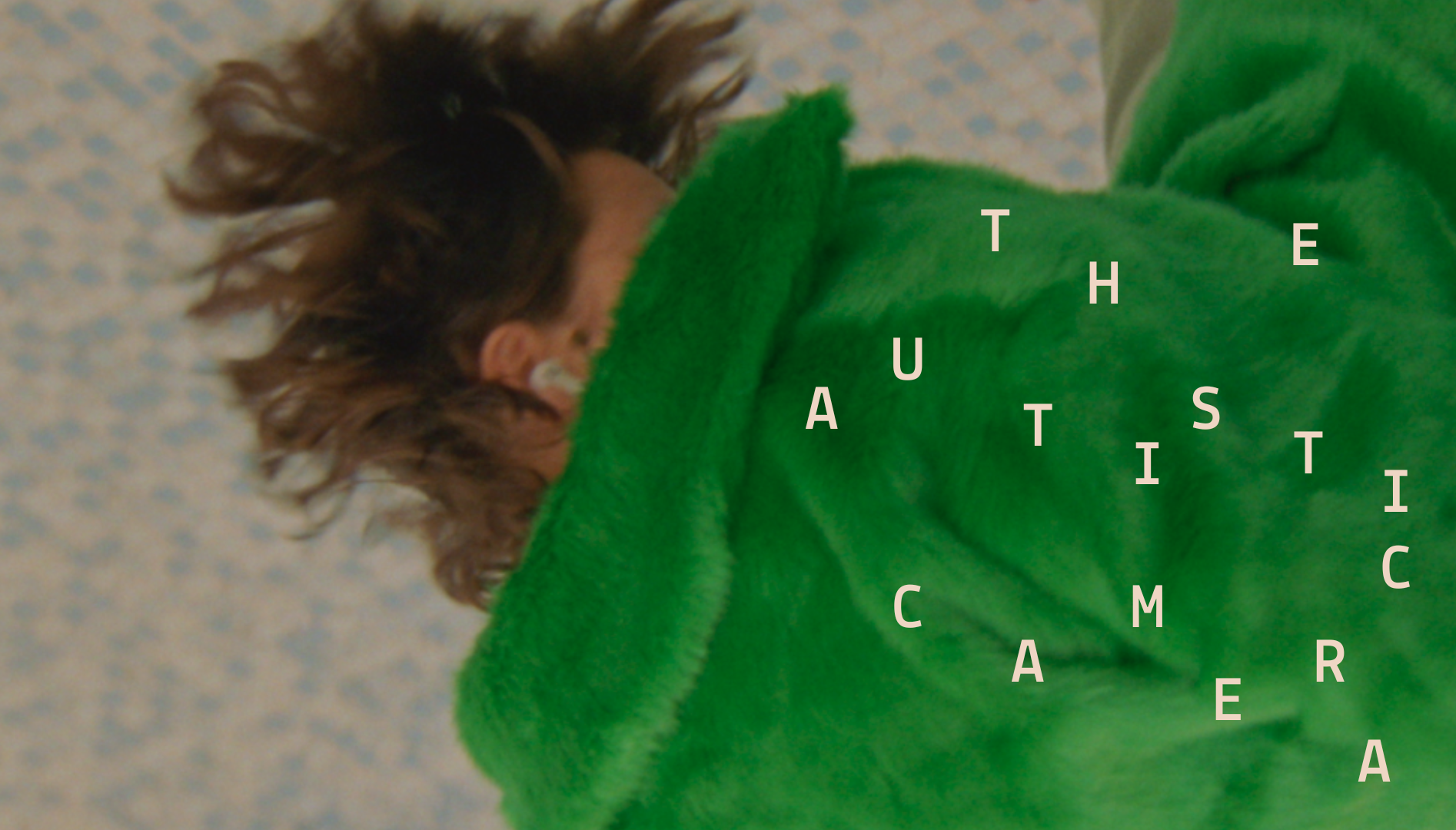 Photo of a person in a green coat laying on the floor.