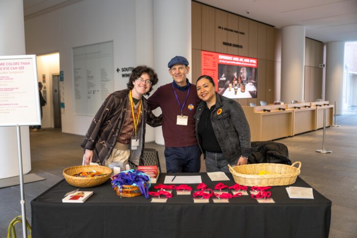 Learning Guide Apollo Beaber and PAM Educator Advisory Members Allen Koshewa and Dora Lisa Chavez welcome educators to MORE COLORS THAN THE EYE CAN SEE Educator Symposium in March 2026. Photo by Keith Scott.