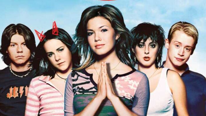 Photo of five teenagers. One with her hands in a prayer pose.