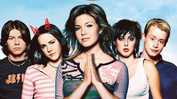 Photo of five teenagers. One with her hands in a prayer pose.