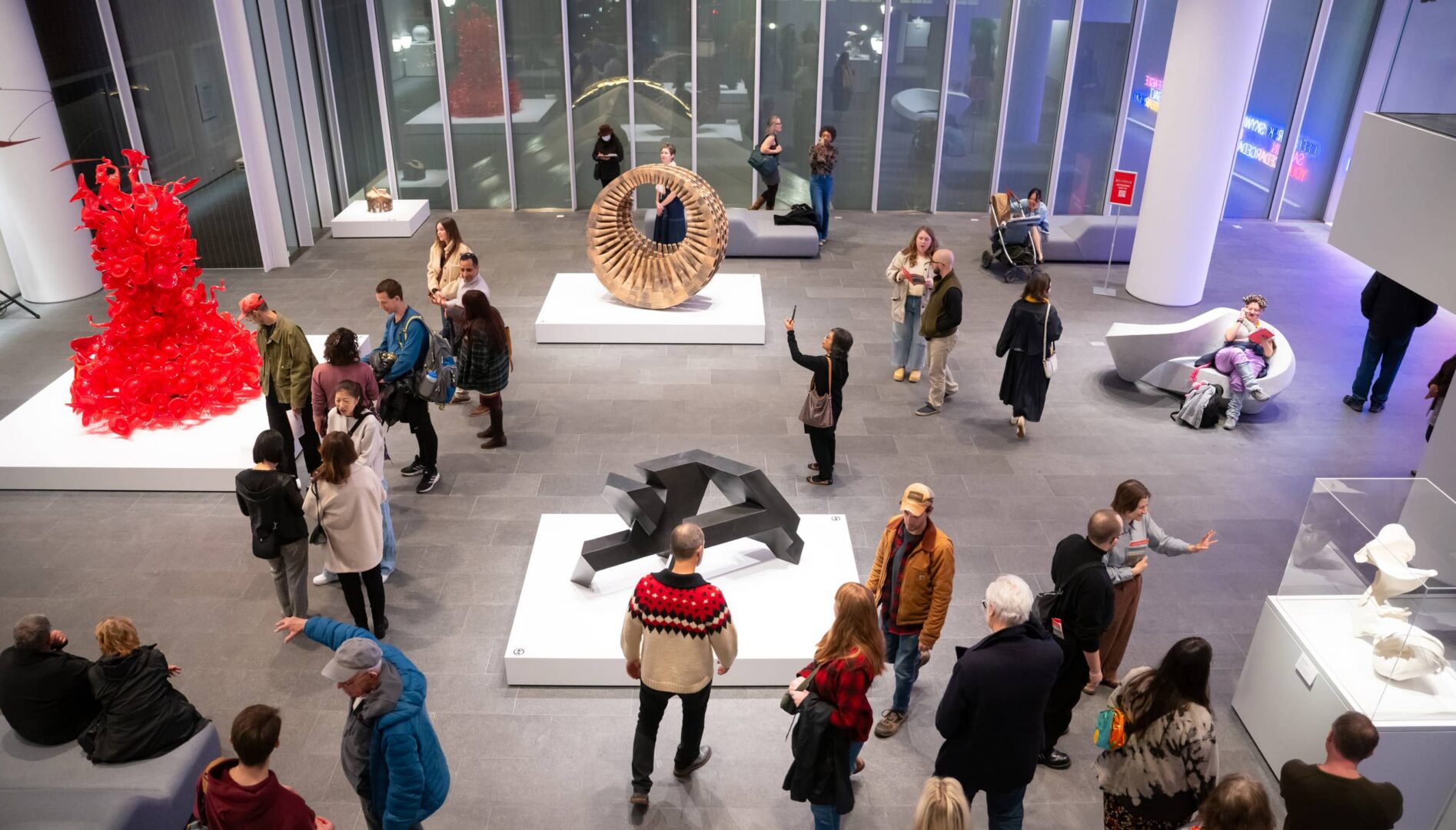 People looking at art in a large, open gallery space.
