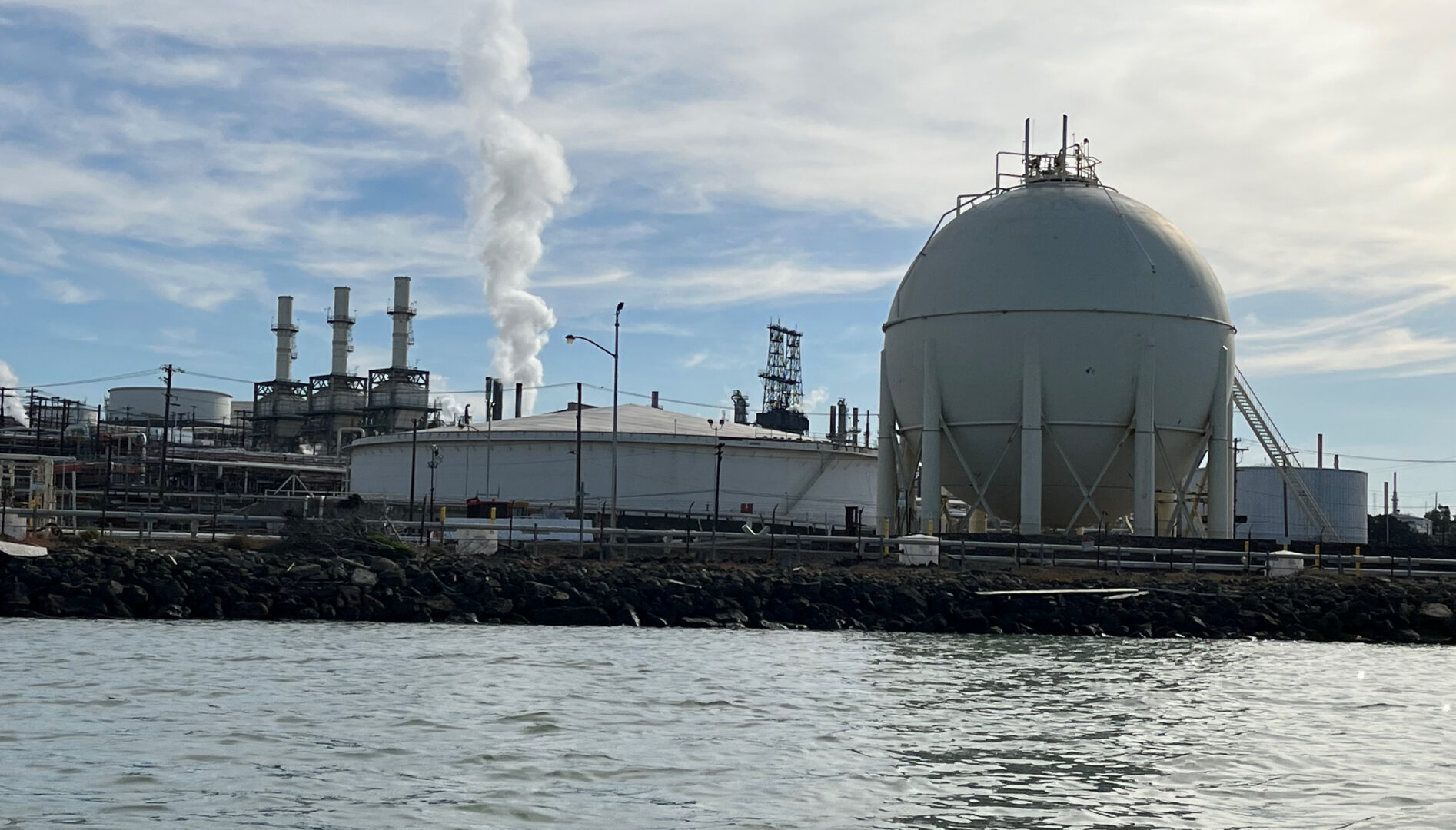 Photo of a factory from across a body of water.