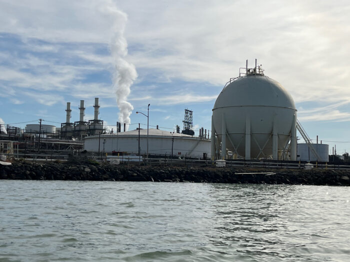 Photo of a factory from across a body of water.