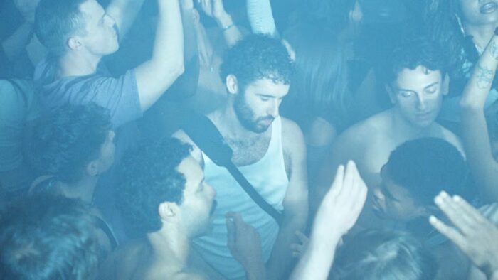 Film still from the movie Club Kid of a group of dancing people.