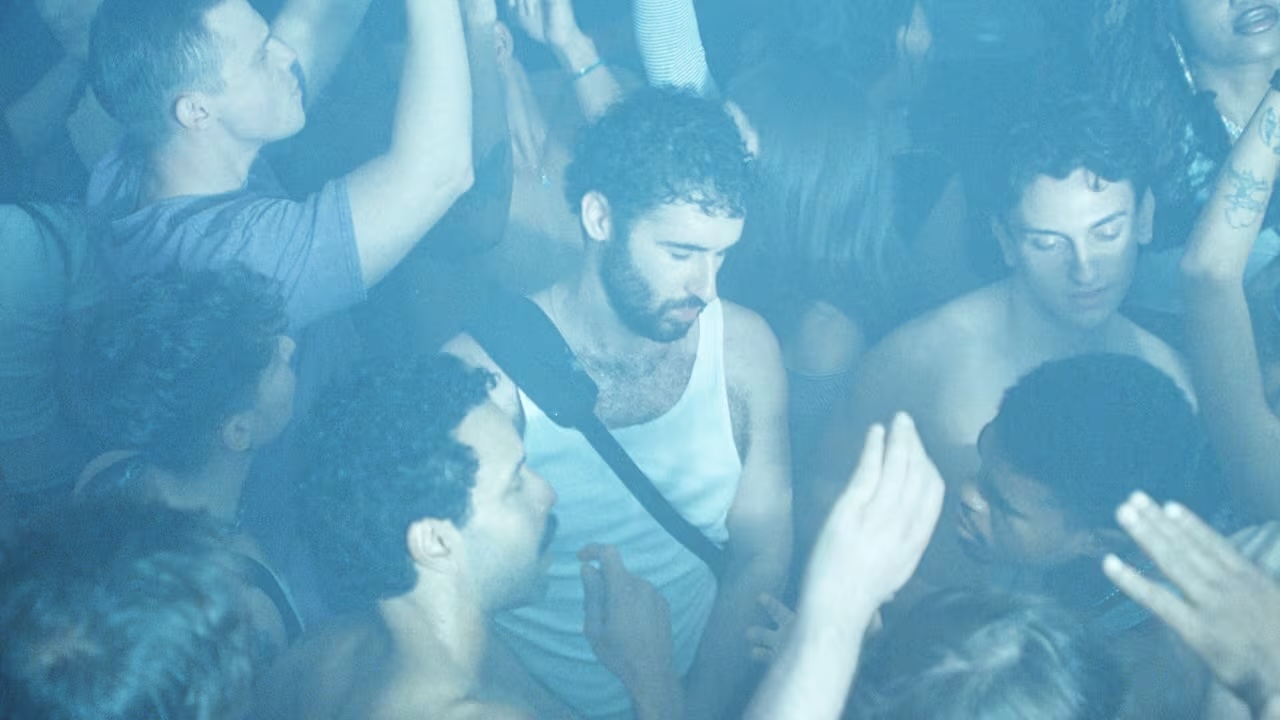 Film still from the movie Club Kid of a group of dancing people.