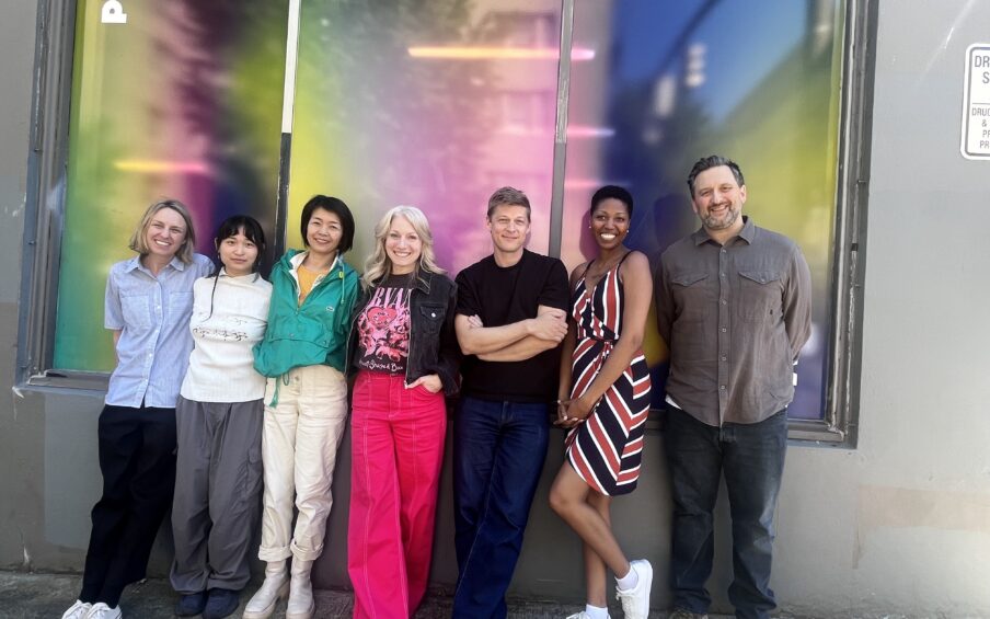 A group of people in front of PAM CUT building