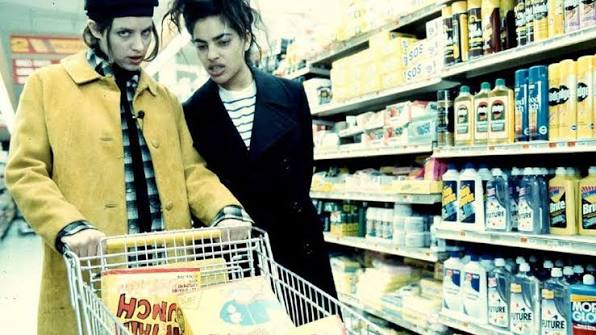 Film still of two people in a grocery aisle.
