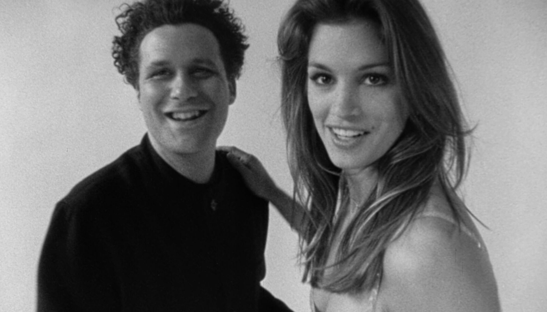 Black and white film still of Isaac Mizrahi and Cindy Crawford.